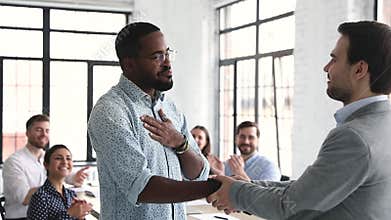 Proud confident african male professional get promoted handshake boss