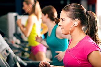 People on treadmill in gym running
