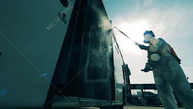 Bus entrance is getting chemical treatment from a disinfector