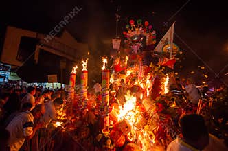 Chinese devotees burn the king of ghost statue during hungry ghost festival.