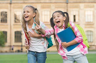 Children are the future. Happy children have fun outdoors. Little children hold study books. Small children back to