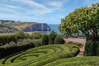 View of Etretat coastline with its famous natural stone arch from the Etretat gardens. Normandy, France.