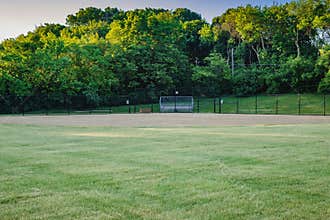The the view from the outfield of a youth baseball field in a city park