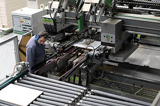 Worker in automatic furniture factory