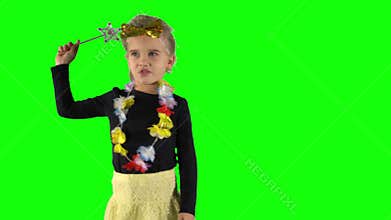 Cute little princess girl holding magic wand and making a spell or curse.