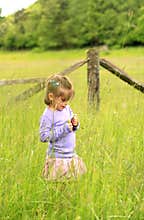 Small Cute Girl in Grassy Field