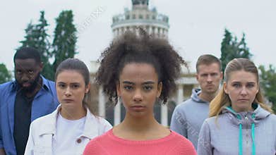 People of divers races raising heads, rally of ethnicity unity, social awareness