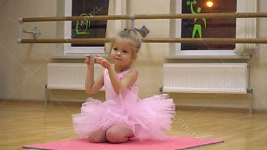 Little girl doing some ballet exercises in the choreography class