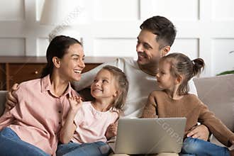 Joyful full family watching cartoons on laptop.