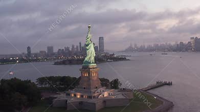 AERIAL: Circling Statue of Liberty beautifully illuminated in early morning light New York City
