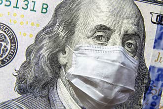 COVID-19 coronavirus in USA, 100 dollar money bill with face mask. COVID-19 affects global stock market