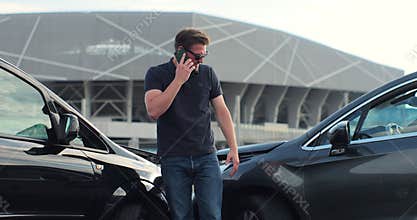 Car accident with wrecked car and man on phone. Man calling to report car accident. Road safety and insurance concept.