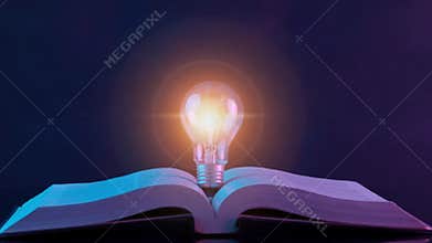 Close up of glowing light bulb on the open book. Inspiring from reading books and education, Innovations,
