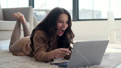 Surprised Caucasian Woman Delighted by News on Laptop