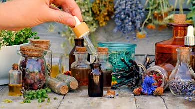 Tinctures and extracts of herbs in a jar. Selective focus.