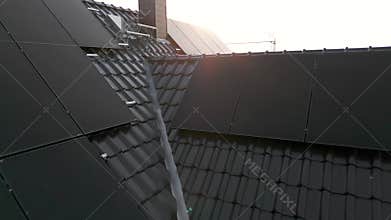 Flight over the roof of a detached house showing newly installed solar panels