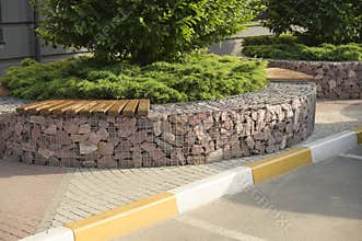 stone borders painted in white and yellow along the road for cars