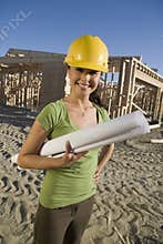 Happy Female Architect Holding Blueprint