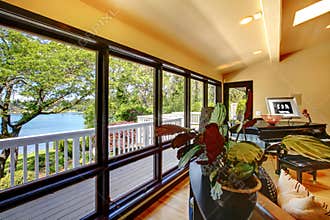 Open modern luxury home interior living room wth balcony window wall.