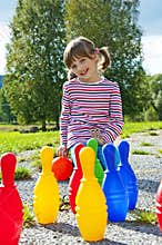 Little girl playing bowling
