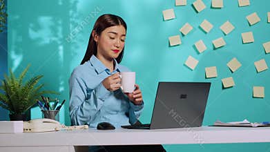 Executive imputing data on laptop