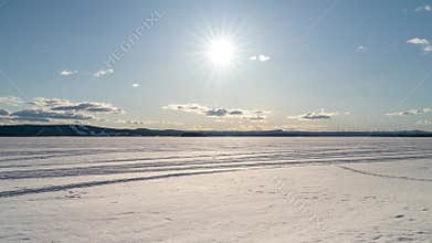 Sunny day in Pitea during spring with clouds in movement over frozen
