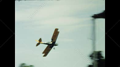 Biplanes performing stunts in a 1970s airshow