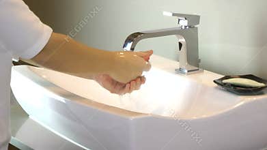 Washing of hands with soap under running water