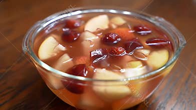 Refreshing Fruit Jelly with Apples and Cherries in Glass Bowl on Wooden Table Delightful Dessert Appetizing Treat Fruity