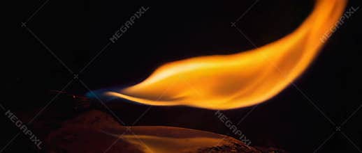 Dramatic flame dance in darkness: intense fire movement and yellow glow