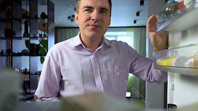 POV point of view from inside refrigerator Caucasian hungry man adult sad upset disappointed male. guy holding onto an