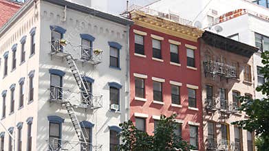 New York City building architecture, Manhattan. Residential house exterior. Red brick, fire escape.