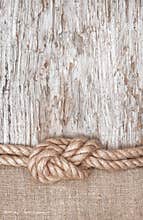 Ship rope, burlap and wood background