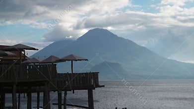 Restaurants on the shore of Lake Atitlan with a volcanic mountain in the background, Guatemala