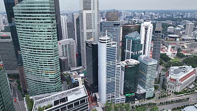 Real time aerial video of Singapore City Skyline. Flying Towards Marina Bay Sands and Gardens In Singapore