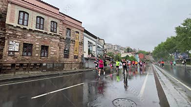 Athletes running Istanbul half marathon in historic street of Fener district