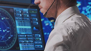 Professional air traffic controller in the control tower. Aircraft control officer works using radar, computer