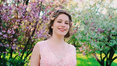 Cute happy adult girl smiling face eyes lips walking in spring blooming garden health concept freedom from allergies