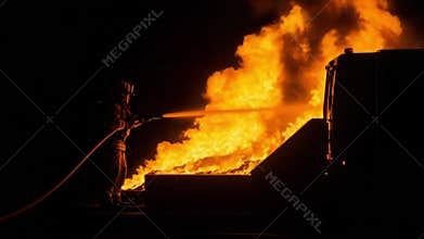 Brave Firefighter Battling Fierce Blaze at Night