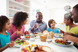 Multi Generation African American Family Eating Meal At Home