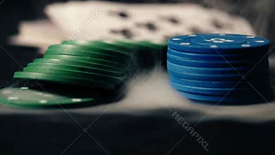 Poker chips and playing cards smoking background