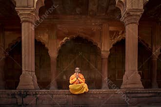 A sadhu sits in deep dhyaan on a Varanasi ghat, lost in spiritual stillness.