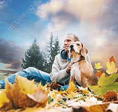 Man with beagle on autumn view landscape