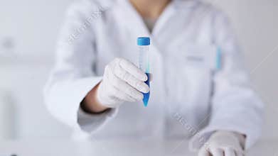 Close up of scientist with full beaker in lab