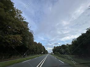 Driving Under a Modern Bridge on an Amsterdam Highway at Golden Hour