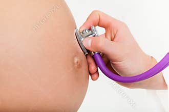 Pregnant woman abdomen and doctor's hand