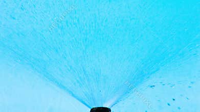 Water sprinkler on blue sky