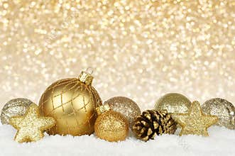 Gold Christmas ornaments with twinkling background