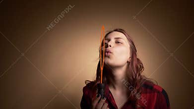 Beautiful girl blowing soap bubbles
