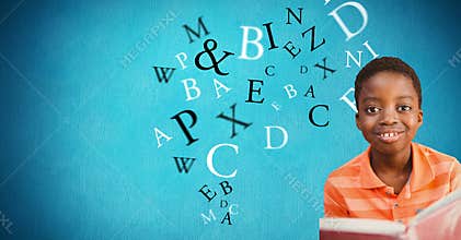 Male student smiling while letters flying in background